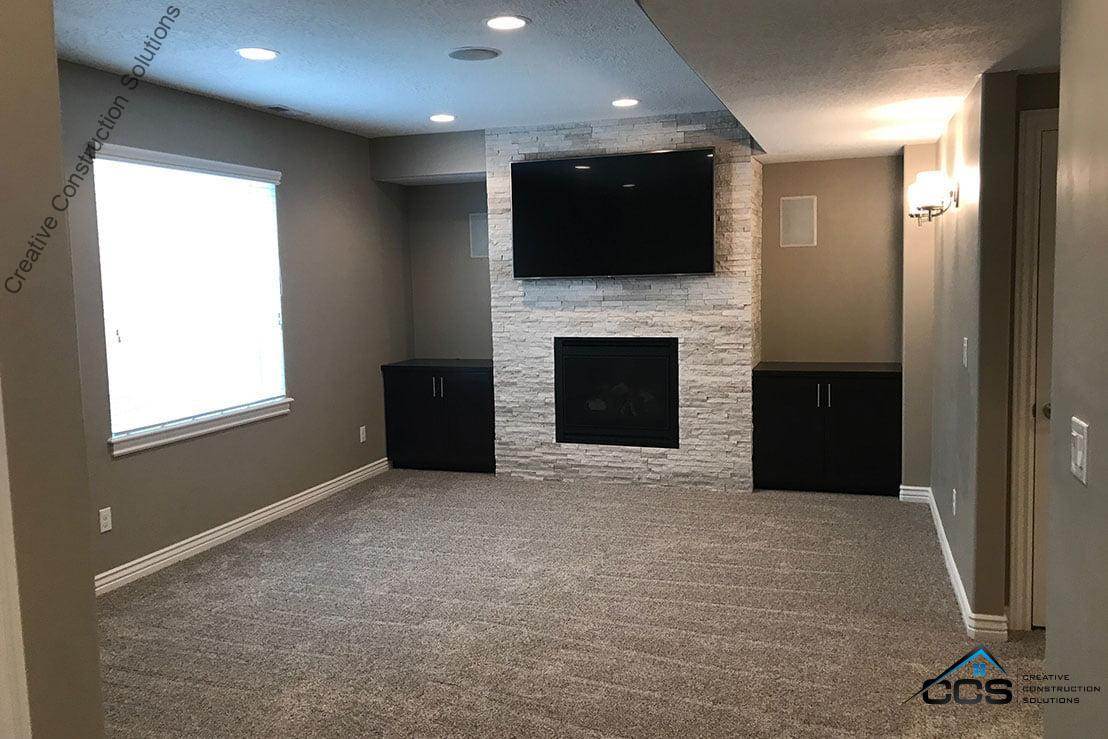 An image of a Utah finished basement. A logo for CCS Creative Construction Solutions of Utah is in the bottom right-hand corner.