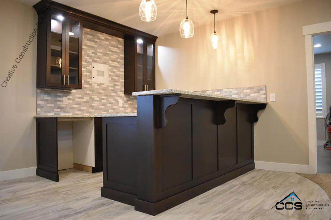 An image of a Utah finished basement kitchenettes bars. A logo for CCS Creative Construction Solutions of Utah is in the bottom right-hand corner.