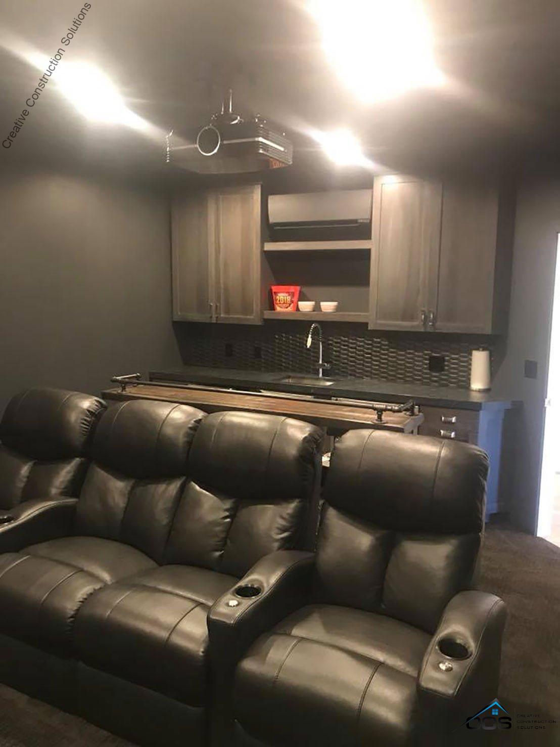 An image of a Utah finished basement theater room. A logo for CCS Creative Construction Solutions of Utah is in the bottom right-hand corner.