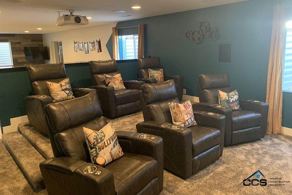 An image of a Utah finished basement theater room. A logo for CCS Creative Construction Solutions of Utah is in the bottom right-hand corner.