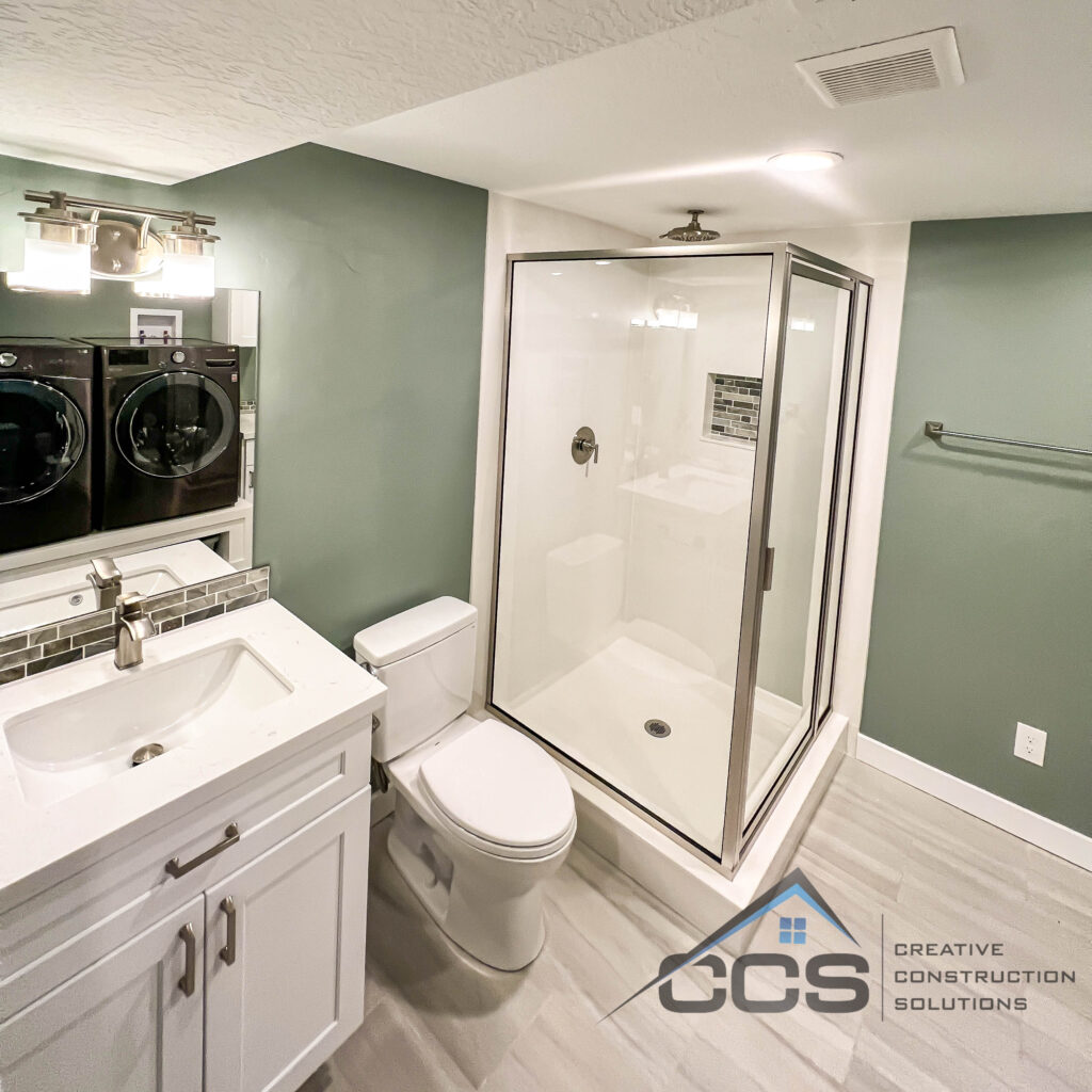 An image of a Utah basement bathroom. A logo for CCS Creative Construction Solutions of Utah is in the bottom right-hand corner.