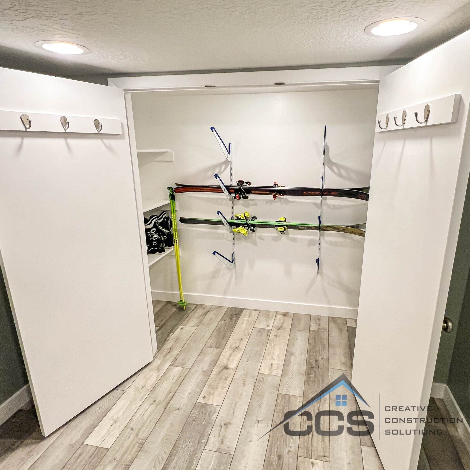 An image of a Utah finished basement. A logo for CCS Creative Construction Solutions of Utah is in the bottom right-hand corner.