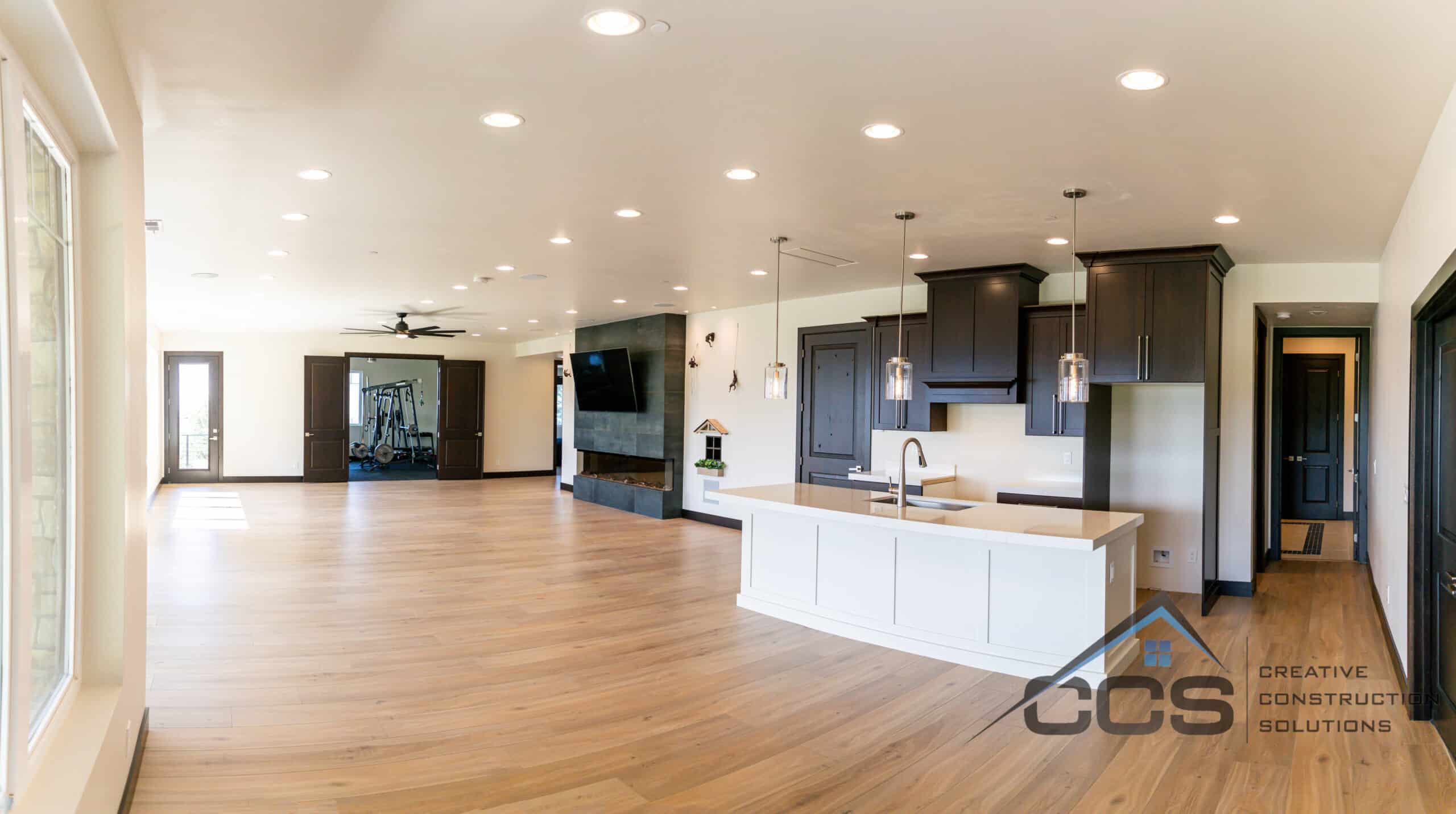 An image of a Utah finished basement. A logo for CCS Creative Construction Solutions of Utah is in the bottom right-hand corner.