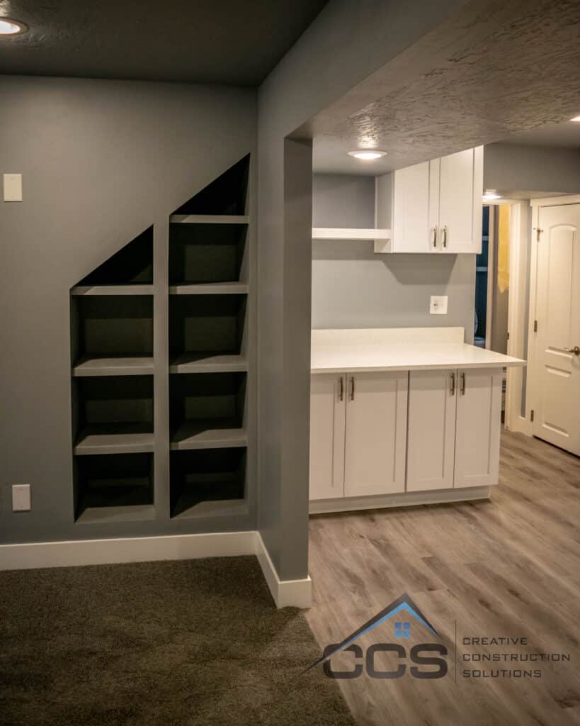An image of a Utah finished basement. A logo for CCS Creative Construction Solutions of Utah is in the bottom right-hand corner.