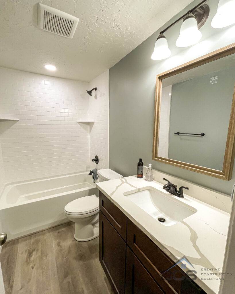 An image of a Utah basement bathroom. A logo for CCS Creative Construction Solutions of Utah is in the bottom right-hand corner.