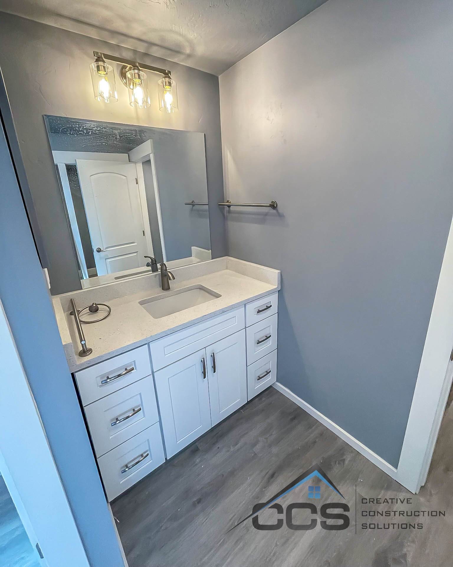 An image of a Utah basement bathroom. A logo for CCS Creative Construction Solutions of Utah is in the bottom right-hand corner.