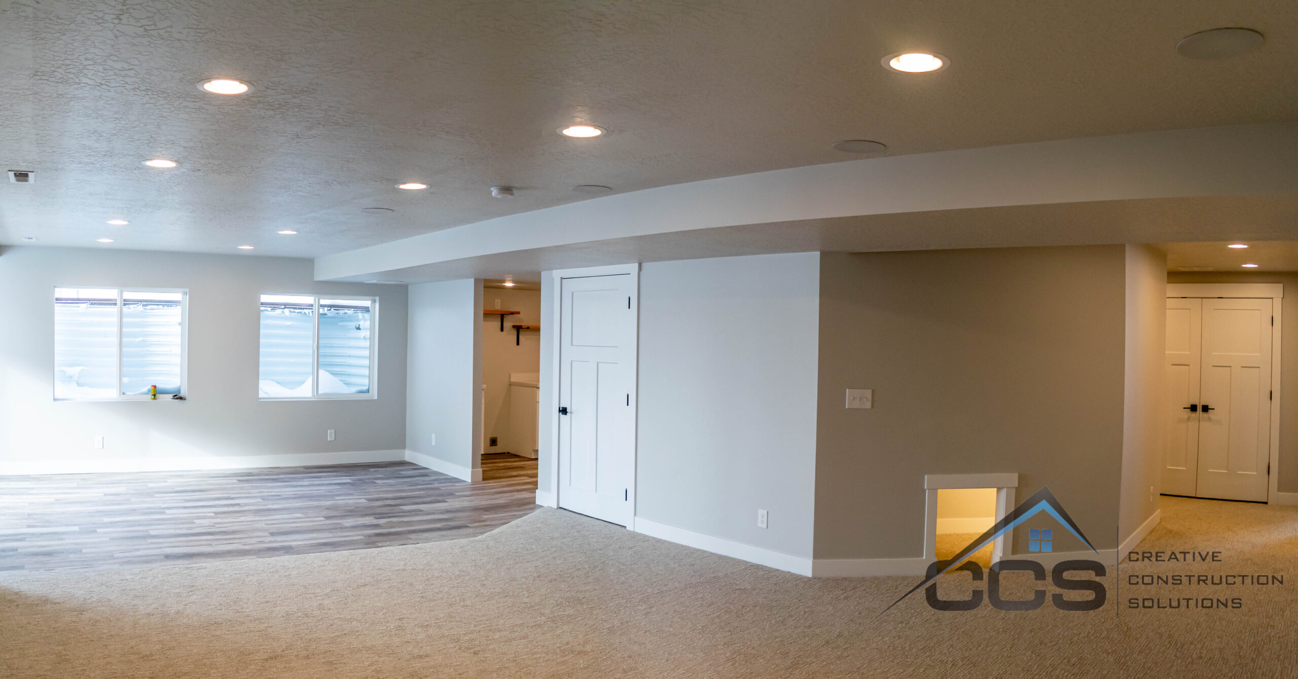 An image of a finished basement in Suncrest, Utah. A logo for CCS, Creative Construction Solutions in is the right hand corner.