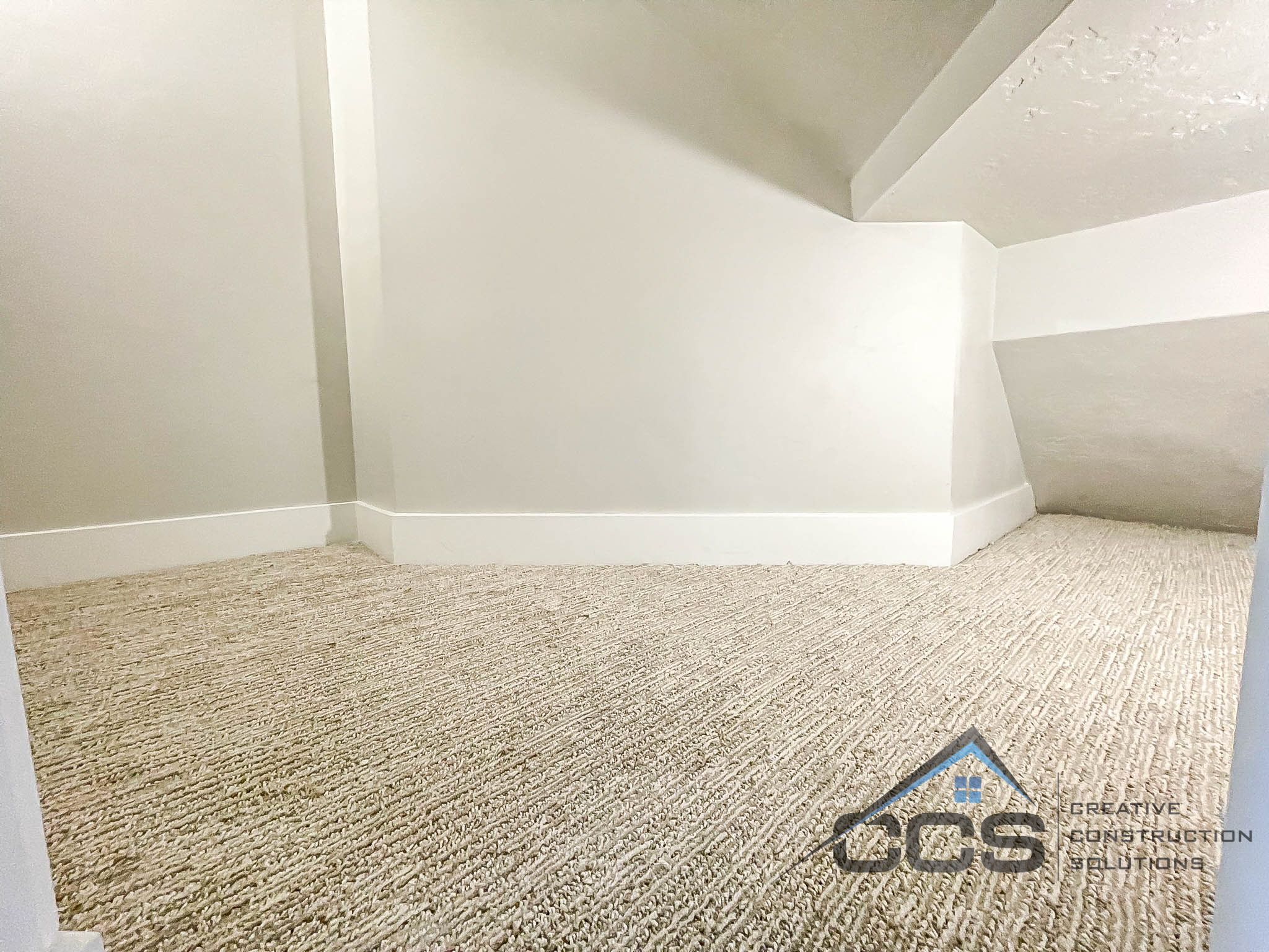 An image of a finished basement in Suncrest, Utah. A logo for CCS, Creative Construction Solutions in is the right hand corner.