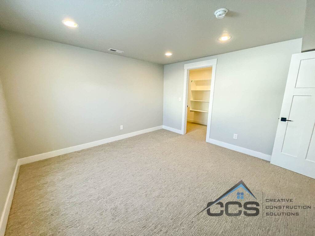 An image of a finished basement in Suncrest, Utah. A logo for CCS, Creative Construction Solutions in is the right hand corner.