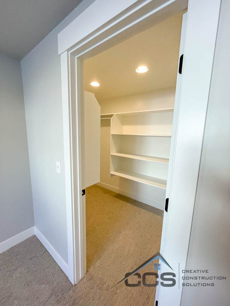 An image of a finished basement in Suncrest, Utah. A logo for CCS, Creative Construction Solutions in is the right hand corner.